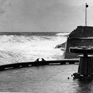 Storm waves crashing against the entrance to Peterhead Harbour in Scotland March