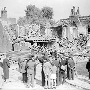WW2 The Blitz Bomb damage in London Local residents stop to look at bomb