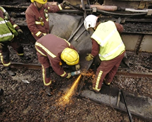 Firefighters using cutting equipment, West London