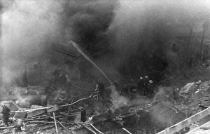 Firefighters in action after air raid, WW2