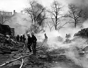 Firefighters in action with hosepipes, Poplar, East London